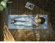 1327801471 | 게티이미지코리아 | Asian woman practicing yoga, using dumbbells during home workout in living room, aerial view... 