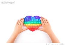 1328282114 | 게티이미지코리아 | Childs hands holding rainbow pop it anti-stress toy. Royalty-Free 이미지