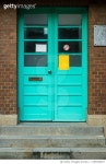 1350434527 | 게티이미지코리아 | A green wooden door of a red building Royalty-Free 이미지