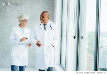 1369431264 | 게티이미지코리아 | Two doctors talking at hospital Royalty-Free 이미지