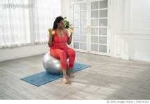 1368151344 | 게티이미지코리아 | Young woman exercising at home using big fitness ball and dumbbell. Royalty-Free 이미지