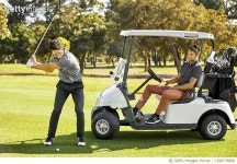 1398778600 | 게티이미지코리아 | Man taking shot while friend sitting in golf cart Royalty-Free 이미지