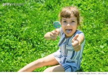 1401756246 | 게티이미지코리아 | Child eats lollipop on nature Selective focus Royalty-Free 이미지