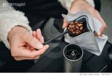 1457320157 | 게티이미지코리아 | Cropped shot of barista while adding coffee beans into manual coffee grinder. Royalty-Free 이미지