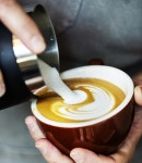 Barista Pouring Steamed Milk Into Coffee Cup Making Latte Art Stock Photo - Image of leaf, barista: 112594544