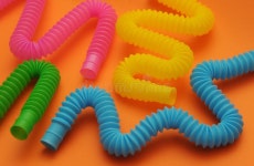 Trendy Toys Pop Tube on Orange Background Stock Image - Image of education, face: 232258621