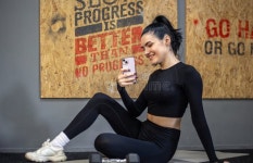 Young Woman in the Gym with a Phone. Gym. Young Woman in the Gym Stock Image - Image of lifestyle, mobile: 343589853