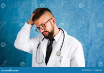 Portrait of a Worried Doctor Against Blue Background Stock Image - Image of serious, background: 176626181
