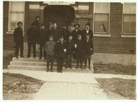 Group of boys working in Friedman Shelby Shoe Co., 6:30 A.M. The youngest, Vehnie Hughes, said he was 12 years old and had been... 