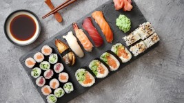 Premium stock video - Composition of different kinds of sushi rolls placed on black stone board