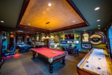 Download A Game Room With A Pool Table And Other Games | Wallpapers.com