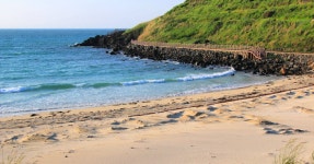 Download A stunning view of Hamdeok beach with a luminous sunrise in Jeju Island, South Korea. Wallpaper | Wallpapers.com