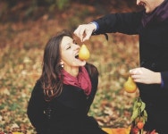 Eat this, honey. Young sweet couple having date in autumn park. | Stock Photo | Colourbox