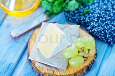 Cheese on wooden board and on a table | Stock Photo | Colourbox
