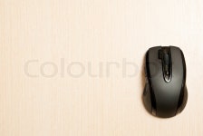 Black wireless pc mouse on table. Studio shot | Stock Photo | Colourbox