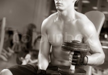 A young man working out in a gym | Stock Photo | Colourbox