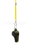 Green whistle with a compass on a yellow cord | Stock Photo | Colourbox