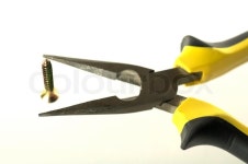 Black and yellow pliers and screw | Stock Photo | Colourbox