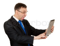 Businessman with a Tablet PC hamming | Stock Photo | Colourbox