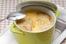 Onion soup on clay pot with melted cheese and bread on top | Stock Photo | Colourbox