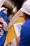 Two workers inspecting ventilation system | Stock Photo | Colourbox