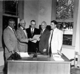 Florida Memory  - Group of men at the Carlon Products Corporation plastic pipe plant signing - High Springs, Florida Group of men... 