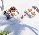 Florida Memory • Parents watching their child play in the sand at the beach - Fort Myers, Florida 