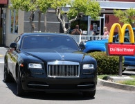 Khloe Kardashian slammed by fans after promoting weight loss supplement on Instagram, as shes pictured at McDonalds drive-in... 