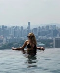 Danielle Armstrong shows off 25-inch waist in black bikini as she poses in infinity pool in Singapore | The Scottish Sun Danielle... 
