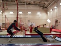 X Factors Johnny Labey puts Louis Walsh through his paces in the gym as the judge takes a tumble on a trampoline