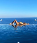 Rita Ora spits water out of her mouth as she strips topless on luxury holiday | The Irish Sun Rita Ora spits water out of her... 