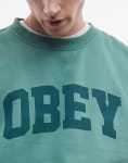 주식회사 오베이153 | 오베이(OBEY) | 오베이 컬리지 스웨트셔츠 그린 & College-Sweatshirt in Grun mit Pigment-Logo und Rundhalsausschnitt...