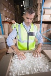 주식회사 웨어하우스케이 | Warehouse worker in yellow vest preparing a shipment | 유토이미지 | 상세페이지 | 베이직샵 | 사진 | 19090101
