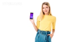㈜인성로지스틱스 | 유토이미지 | beautiful young woman holding smartphone with shopping application on screen and smiling at camera isolated on white