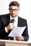 businessman in suit holding paper and speaking during conference isolated on white | 유토이미지 | 상세페이지 | 베이직샵...