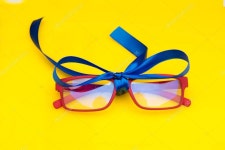 Modern glasses with a bow, ready to be given away — Stock Photo © jorgebotella #324801248 Modern glasses with a bow, ready to...
