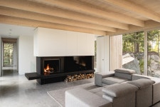 natalie dionne architecture embeds wooden house into rocky canadian forest