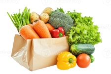 A paper bag filled with various fresh vegetables including carrots, potatoes, broccoli, lettuce, peppers, cucumber, tomatoes, and...