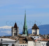 Famous green bell tower of Saint-Pierre Cathedral and Mont-Blanc mountain behind by beautiful day, Geneva, Switzerland | Stock...